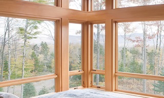 Corner casement windows in a bedroom.