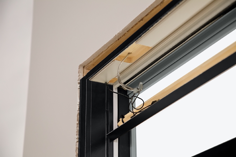 Marvin Lock Status Sensor window security system being installed on a Marvin window.