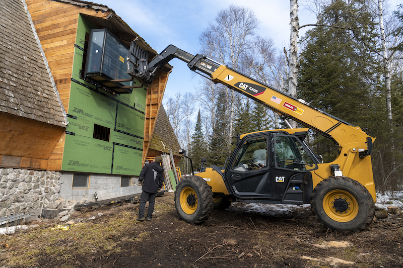 An exterior photo of installing Marvin Skycove on the second floor of The Minne Stuga, an A-frame cabin in Grand Marais, MN.