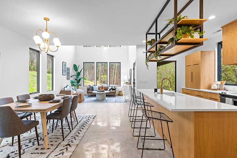 A home’s first floor, featuring Marvin Essential windows and doors and modern furnishings.