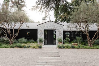 Exterior photo of Amber Lewis’s Belgian farmhouse-style home in Los Angeles, featuring Marvin Signature Ultimate windows and doors.