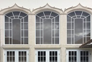 Exterior of building with Marvin Signature Coastline Outswing French Doors and Marvin Signature Coastline Polygon Windows