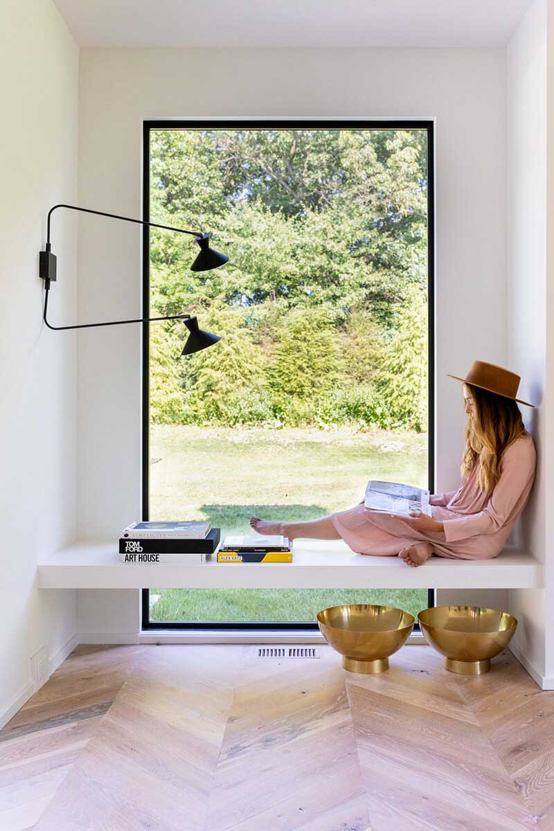 Woman sitting in front of large Marvin window