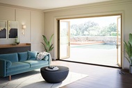 Living room with open Elevate Bi-Fold Door