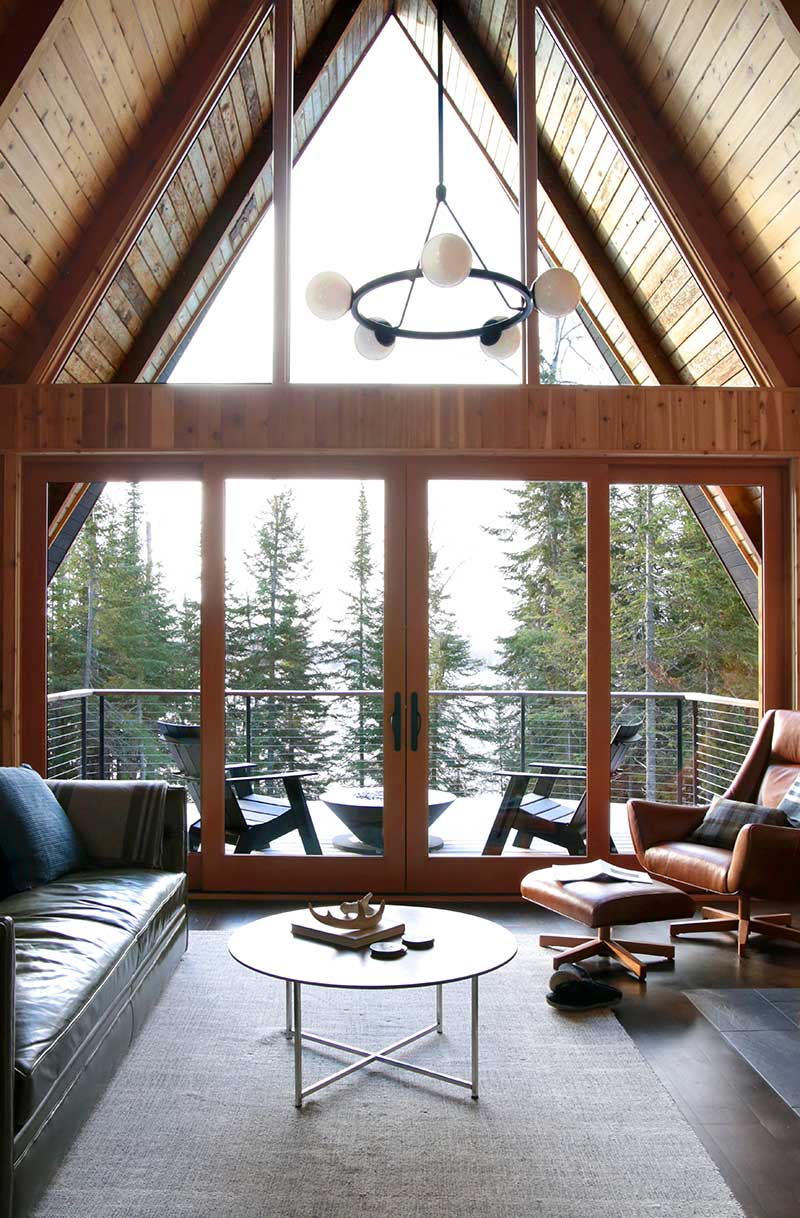 The Great Room in The Minne Stuga, featuring a Marvin Ultimate Sliding French door and Ultimate Picture and Polygon windows overlooking Devil Track Lake.