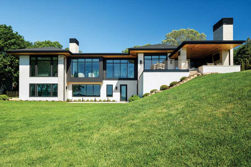 Exterior of the back of a Modern home in Minnetonka, Minnesota with Marvin Modern casement and direct glaze windows and Modern multi-slide doors.