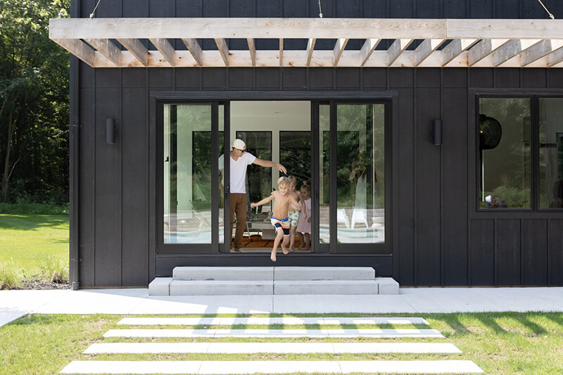 Exterior view of Farmhouse with large Marvin Sliding Door