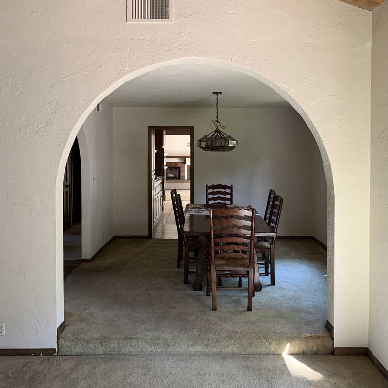 A before image of the dining room in the Bobby Berk Firm’s office space, which was previously a dated 70s Spanish Mediterranean home.