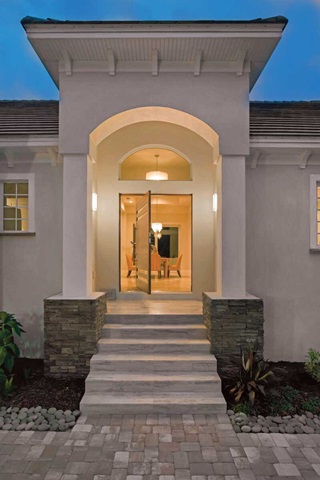 Entryway of home with Marvin Signature Coastline Casement window and Marvin Signature Coastline Pivot Door