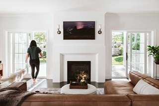 Woman walking out an open Marvin Elevate Sliding French Door in living room