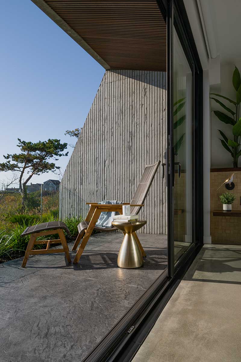 The patio of a private guest suite at the Viewpoint Hotel in York, Maine, through a Marvin Elevate Sliding door.