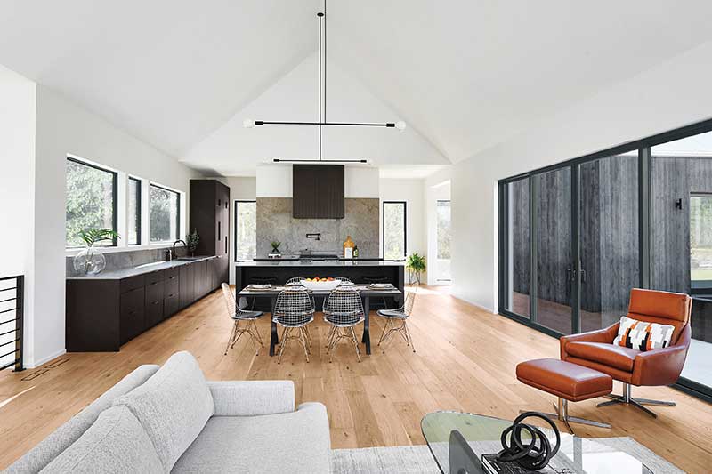 A clean, bright design ties together this combined living room kitchen with Marvin Elevate Sliding Patio door, Essential Casement windows and Essential Direct Glaze windows.