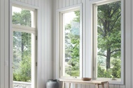 The entryway of a home with a rug and bench, featuring Marvin Essential awning windows