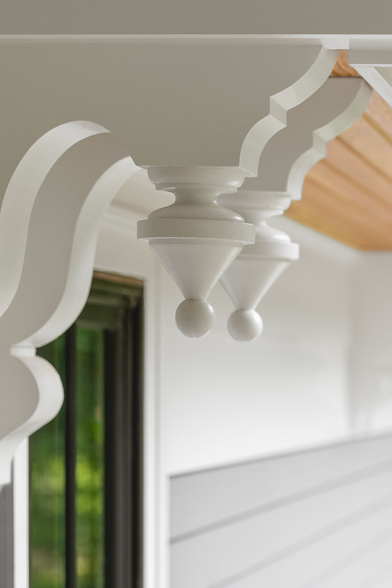 A detail image of the porch on Hadley House, featuring Marvin windows and TruStile doors.