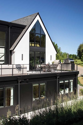 Exterior image of a home with a second story outdoor patio