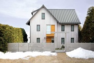 Exterior image of home with modern windows and snow in the yard