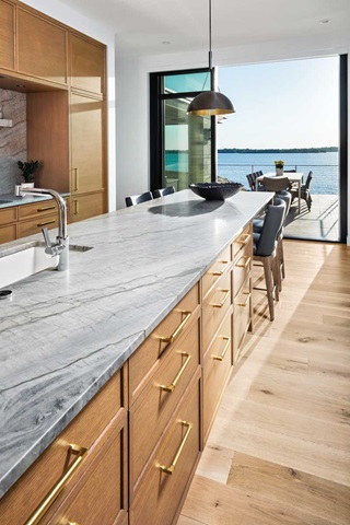 Kitchen with large island and modern windows looking out to lake