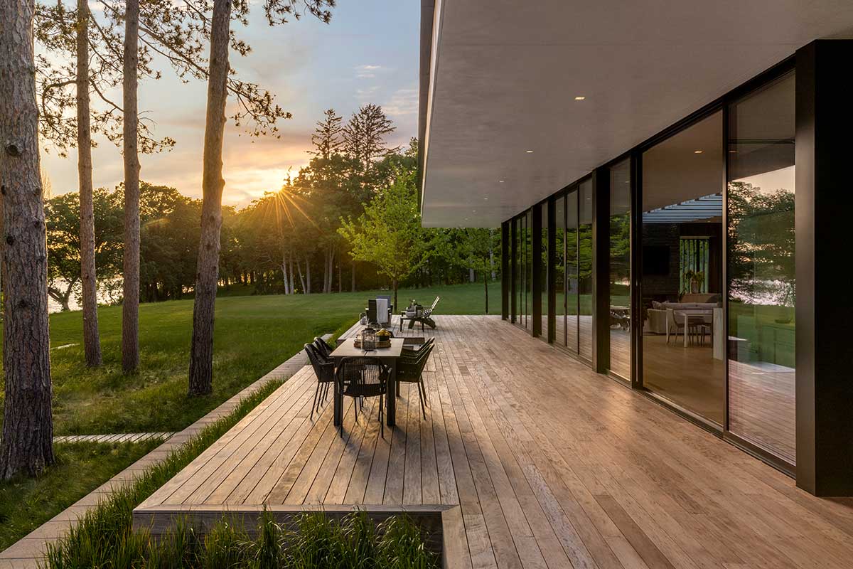 The back deck of a modern home on Lake Minnetonka, featuring Marvin Modern Multi-Slide doors.