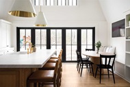 Dining room with Marvin Signature Ultimate Bi-Fold Door and Marvin Elevate Direct Glaze Windows