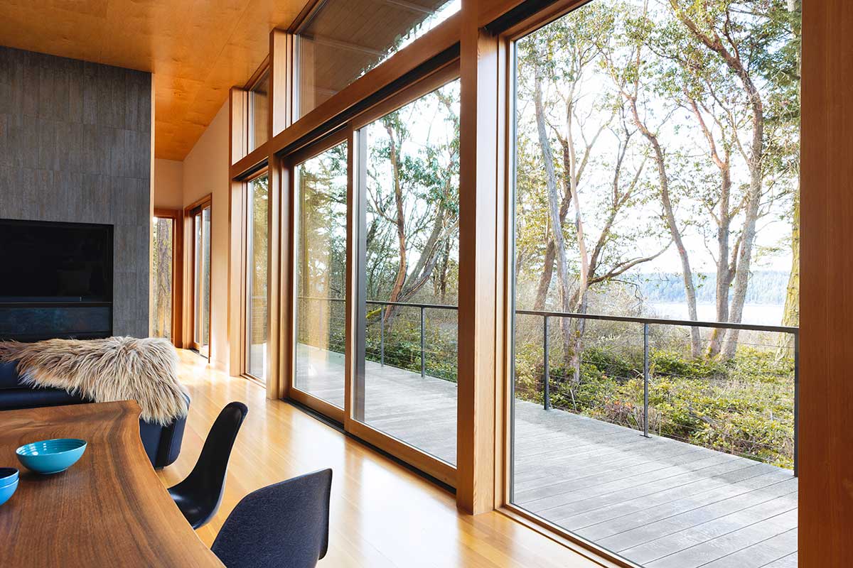 A modern dining room, featuring a Marvin Ultimate Multi-Slide door.