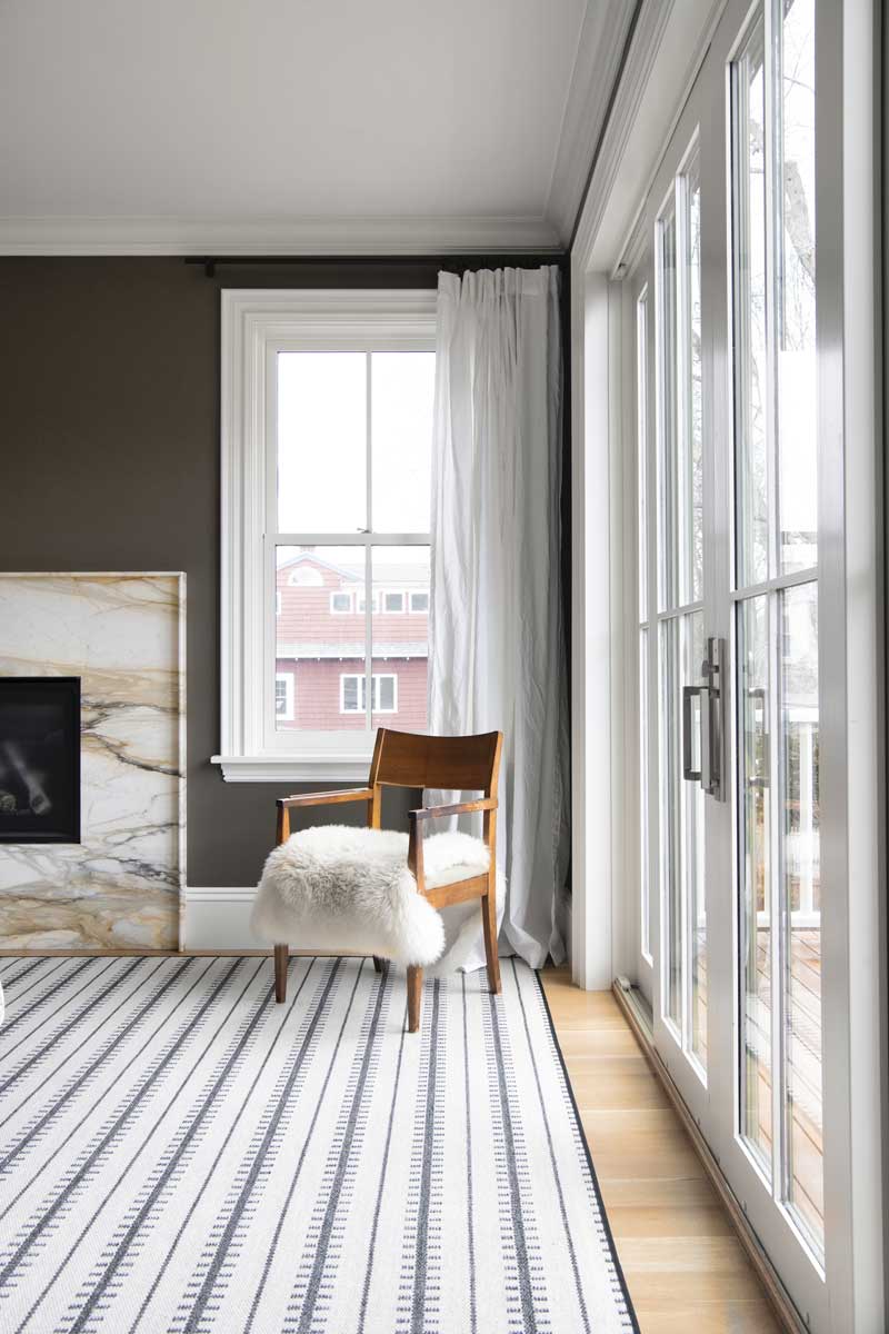 A sitting area in the primary bedroom of an Italianate home, featuring Marvin Ultimate Double-Hung G2 windows and an Ultimate Sliding French Door.