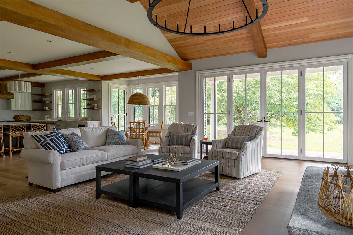The living room of a historic home, featuring Marvin Ultimate Inswing Narrow Profile doors and Ultimate Double Hung G2 windows.