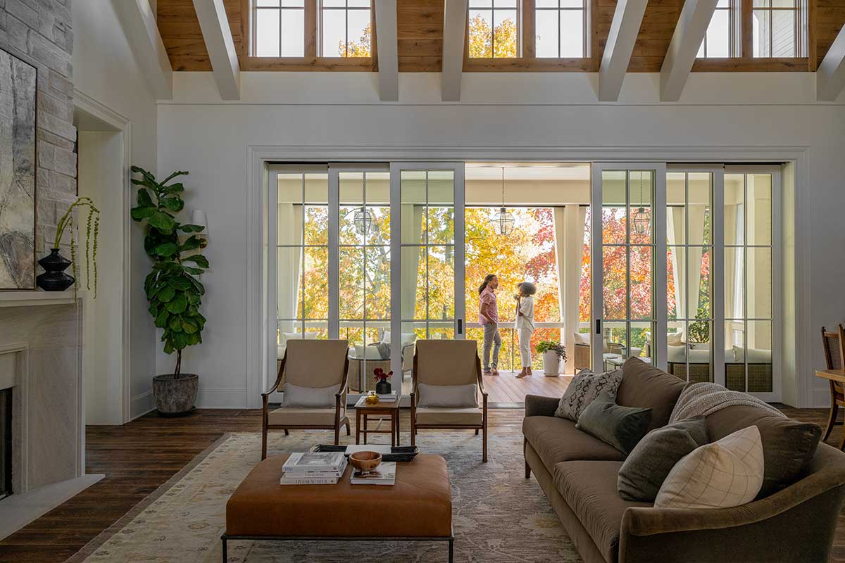 Two people standing on the deck of a home in Nashville, Tennessee, through a Marvin Ultimate Multi-Slide door.