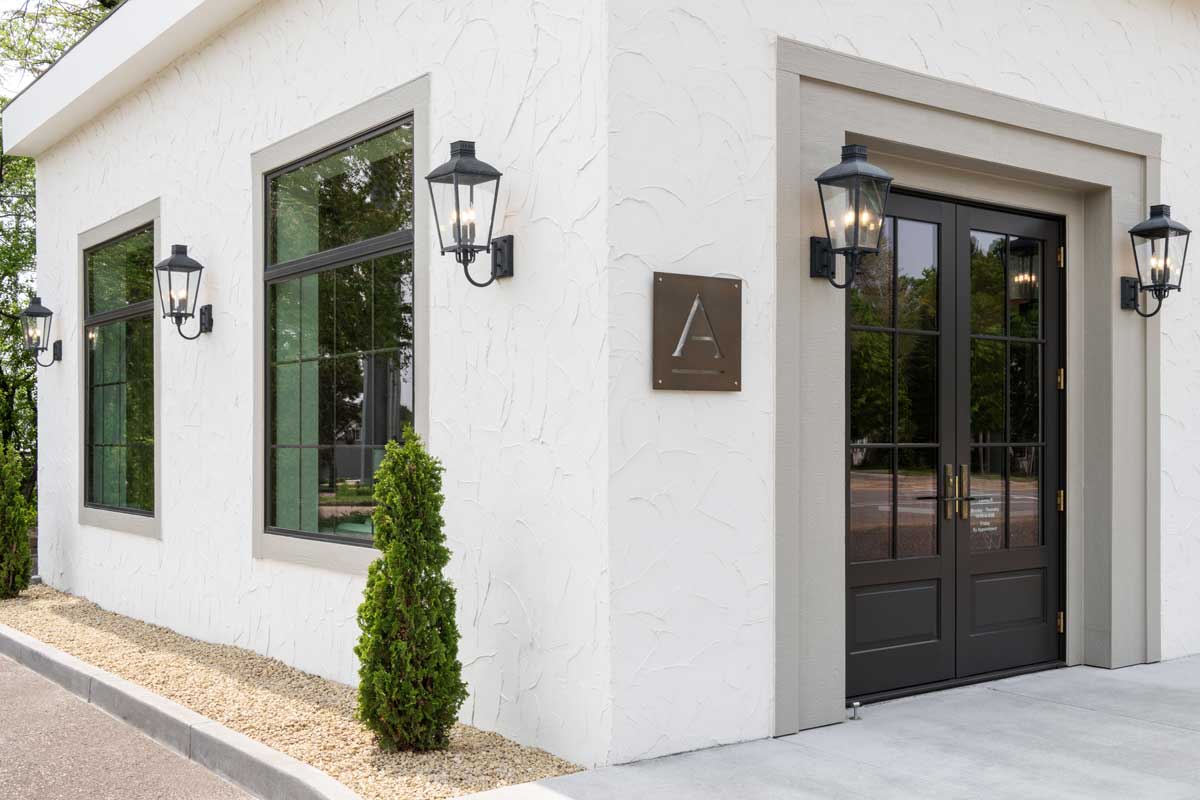 The exterior of the Adorned Homes office space, featuring Marvin Essential Direct Glaze windows and Ultimate Outswing French door G2.