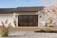The exterior of a ranch home featuring  a Marvin Signature Ultimate Sliding Patio door