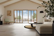 An open clean living room with vaulted ceilings and a Marvin Signature Ultimate Sliding Patio door