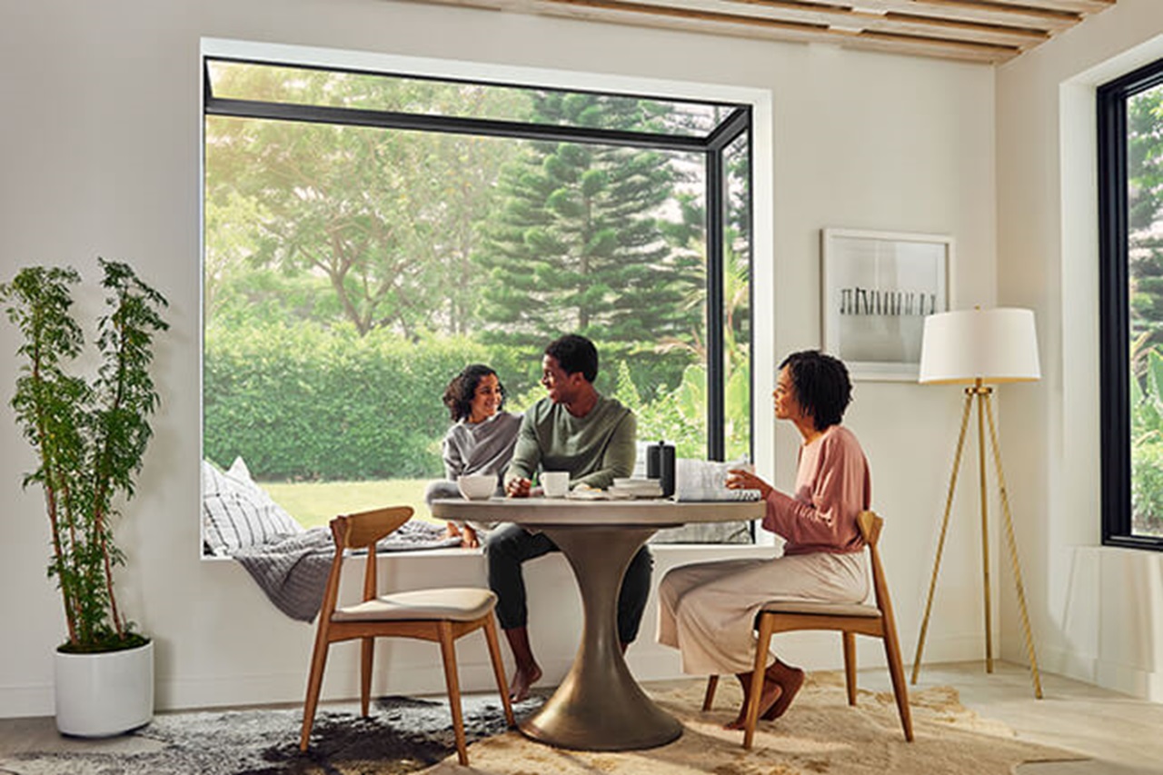 family sitting at table in front of Marvin Skycove box window structure