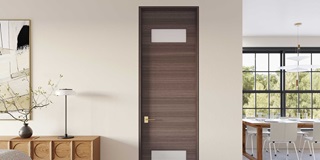 A living room with mid-century modern furniture and a dark brown TruStile door.