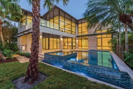 Exterior of home with Marvin Signature Coastline Awning Direct Glaze Casement Windows and Marvin Signature Coastline Multi-Slide Door