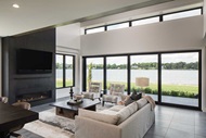 Living room with Marvin Signature Ultimate Multi Slide Door, casement narrow frame windows, awning windows and narrow frame picture windows