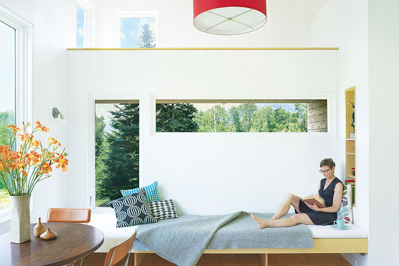 The eating and living area of a micro house in Vermont, featuring Marvin windows and doors.