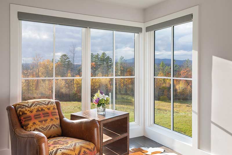 An arm chair with Marvin Ultimate Picture windows with simulated divided lite bars.