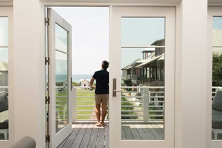 Vern Yip On Balcony Of Coastal Home With Marvin Windows And Doors