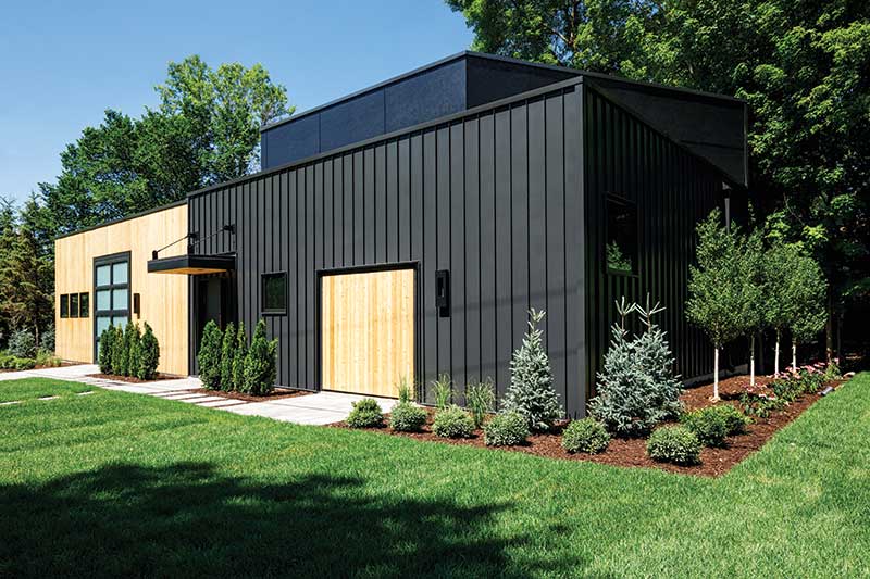 Modern industrial-style home in Orono, MN featuring Marvin Ultimate Awning windows and unique garage door design and placement.
