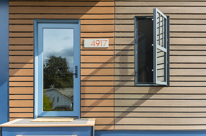 A close-up photo of Michael Anschel’s southwest Minneapolis home, featuring Marvin Ultimate Inswing French Door and a blue casement window. 