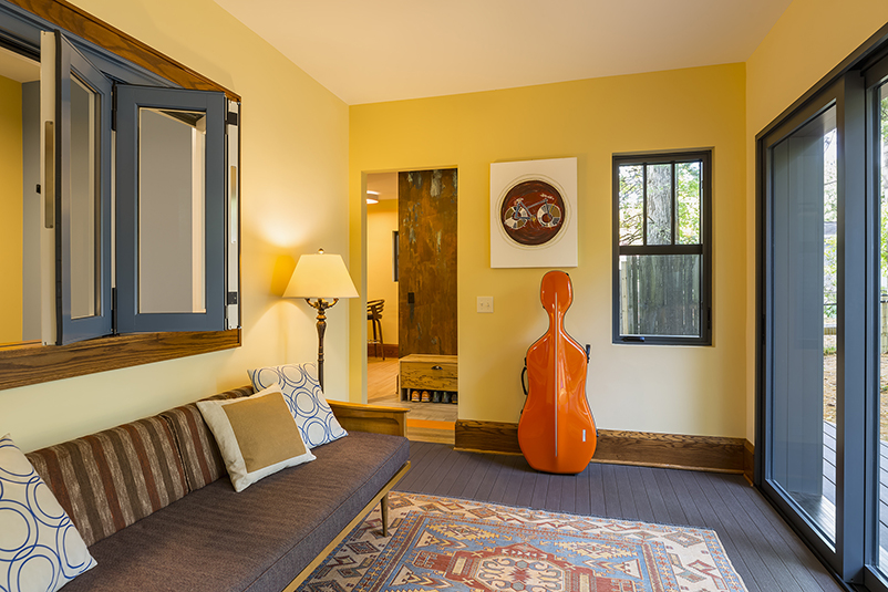 The sunroom of Michael Anschel’s southwest Minneapolis home, featuring a Marvin Signature Ultimate Bi-Fold Door and interior casement windows.