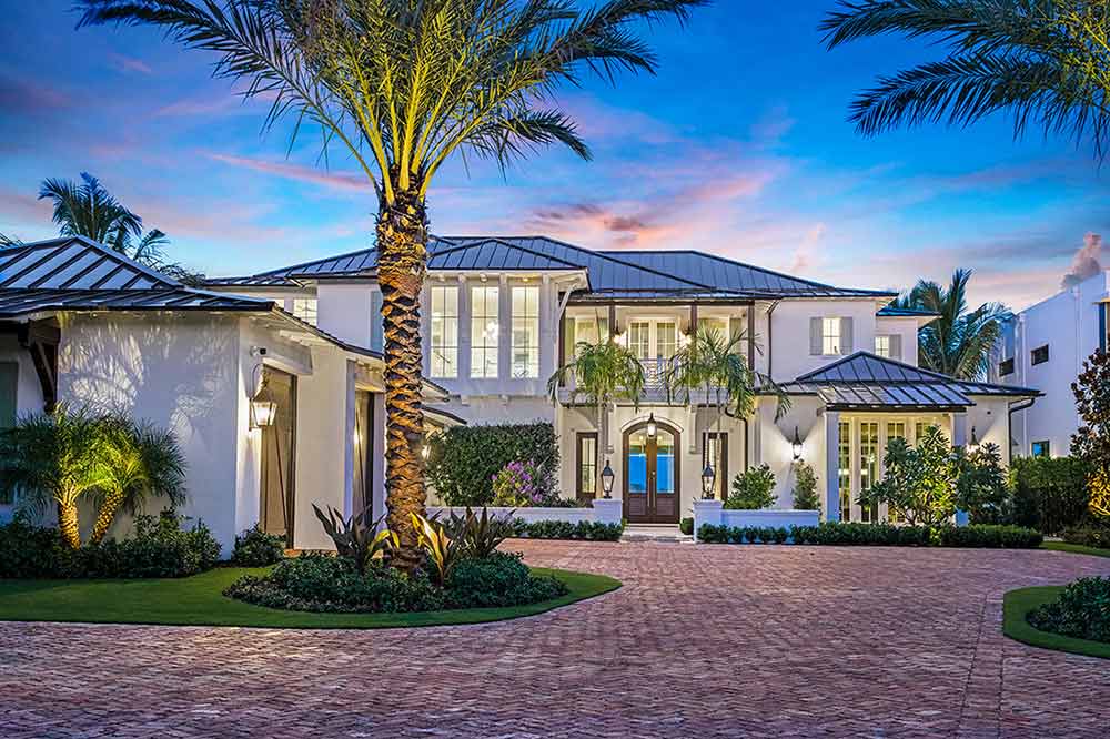 The exterior of a home in Jupiter, Florida, featuring Marvin Coastline Multi Slide Door, Coastline Picture Windows and a Coastline Outswing French Door.