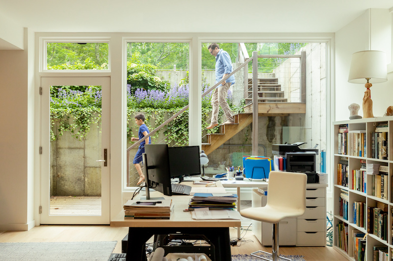 A lower-level office in a home with a separate entrance, featuring Marvin Ultimate picture windows.