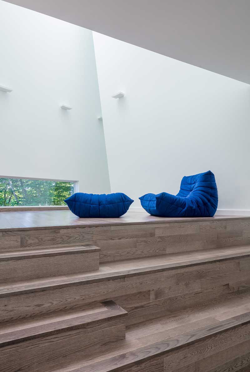 A wooden stage inside a contemporary home for musicians, featuring Marvin Elevate windows and doors.