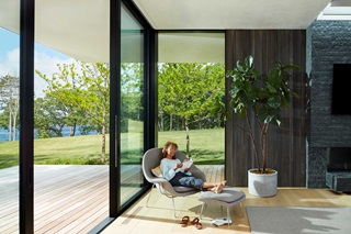 Woman reading a book in front of Marvin Windows and Doors