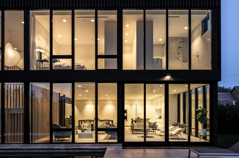 An exterior shot of a modern home in Sag Harbor, New York, designed by THE UP STUDIO, featuring Marvin Modern windows and doors. 