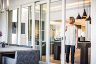 Woman Opening Signature Ultimate Multi-Slide Door