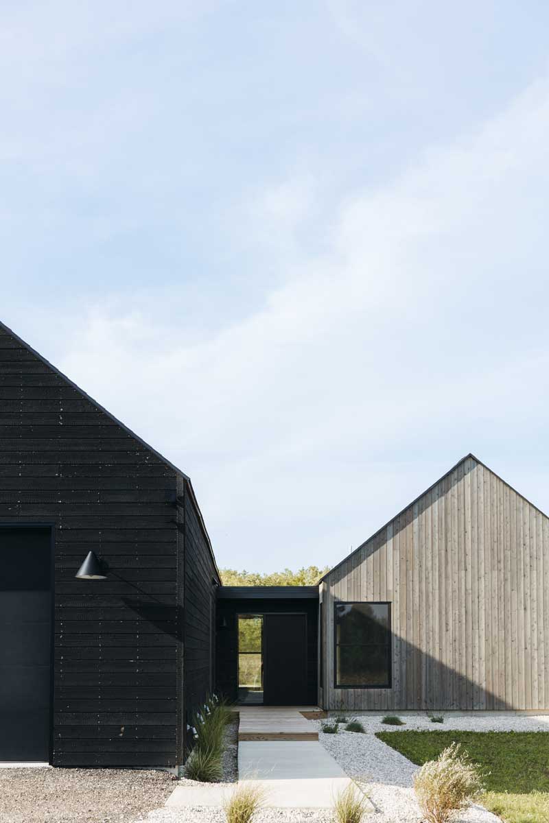 A closeup detail of Nakamoto Forestry siding showing it’s textured surface next to a thinly framed Marvin Essential window at Svart Hus in Door County, Wisconsin. 