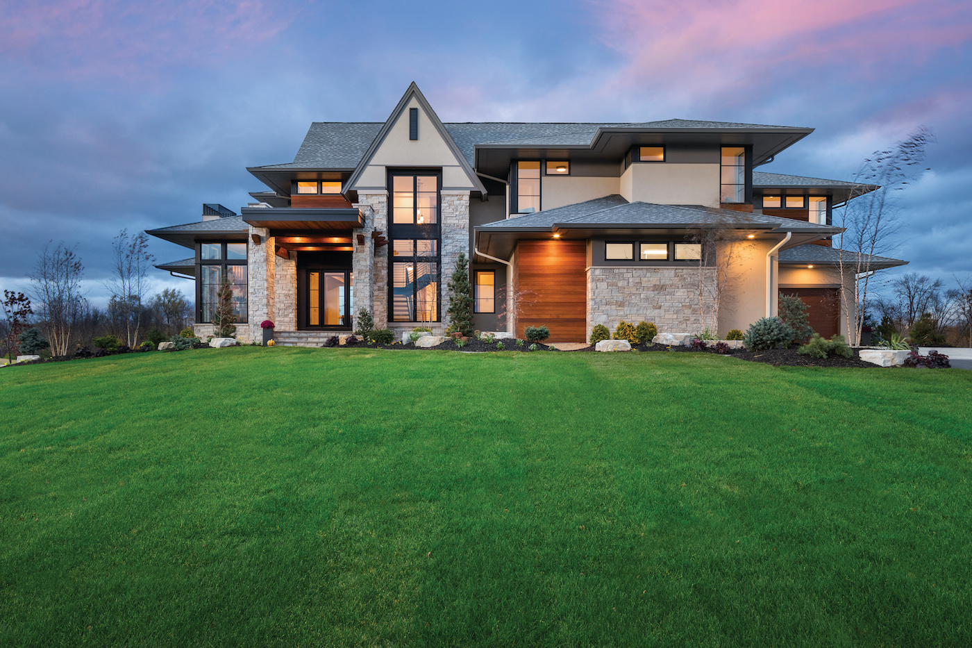 Exterior of a home featuring Marvin Signature Ultimate awning, casement and picture windows.