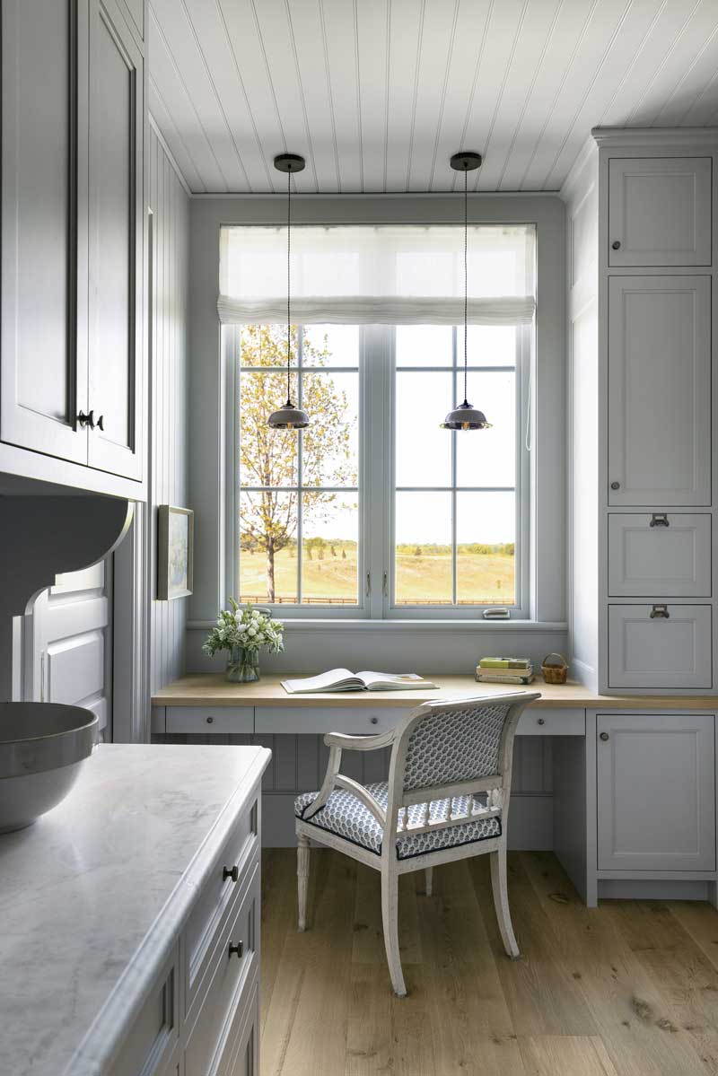 A desk area with a chair and window