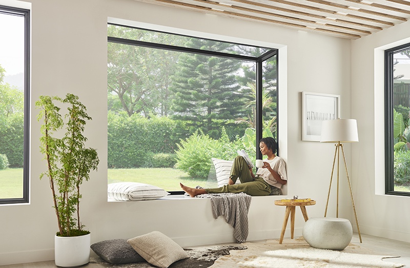 A woman drinking coffee and reading in a Marvin Skycove.